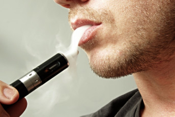 E Cigarette User Exhaling Vapor Smoke - Vape Pen e cig Device