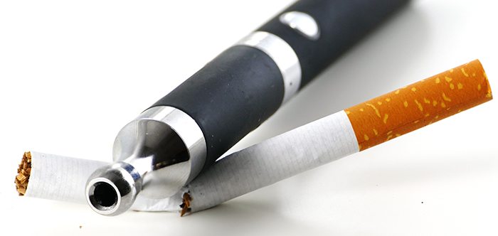 e-cigarette breaks tobacco cigarette, isolated on white backgrou