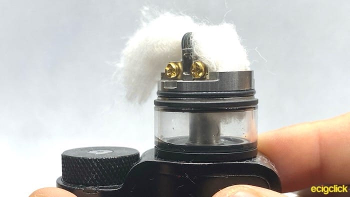 Showing a side view of the Vandy Vape Pyro V3, showing one side of the wick tucked into the tank