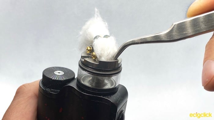 Tucking one side of the wick into the tank on the Vandy Vape Pyro V3