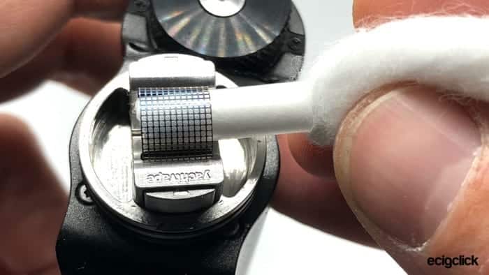 Inserting a piece of agleted cotton through the mesh loop of the Yachtvape RDA