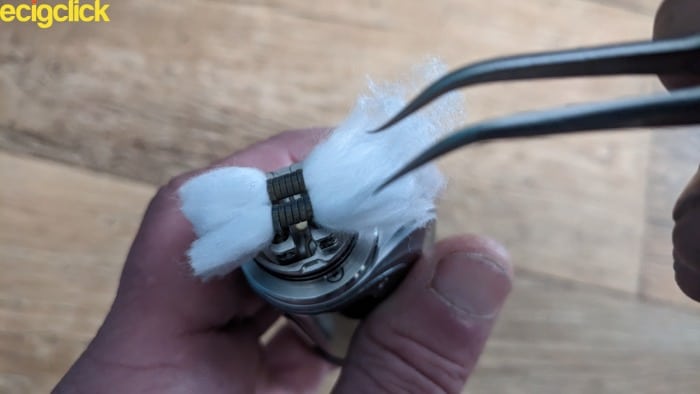 Raking the cotton of the Drop V2 RDA